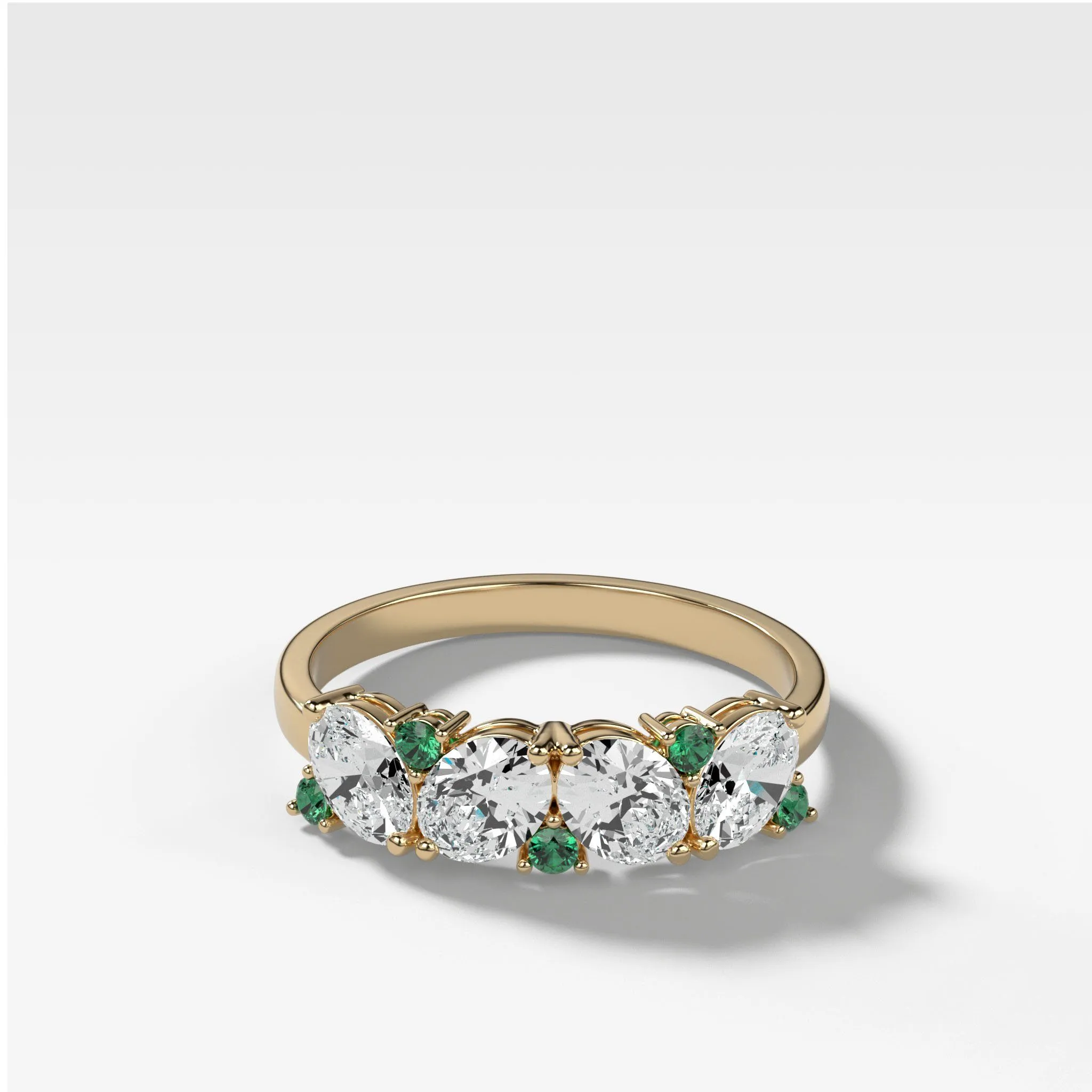 Oval Diamond And Green Emerald Medley Halfway Wedding Band