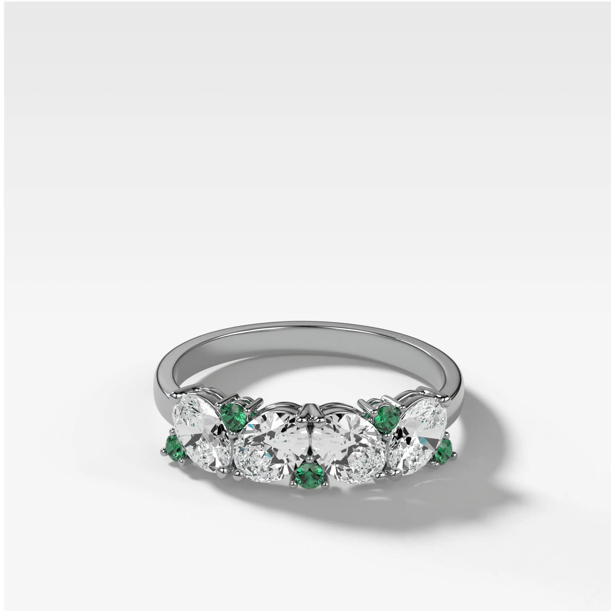 Oval Diamond And Green Emerald Medley Halfway Wedding Band